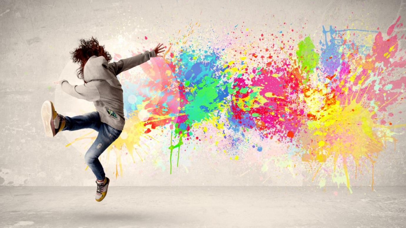 Teen dances against colorful background
