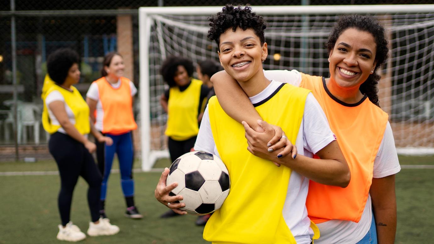 Portrait of a female couple of soccer players on the field