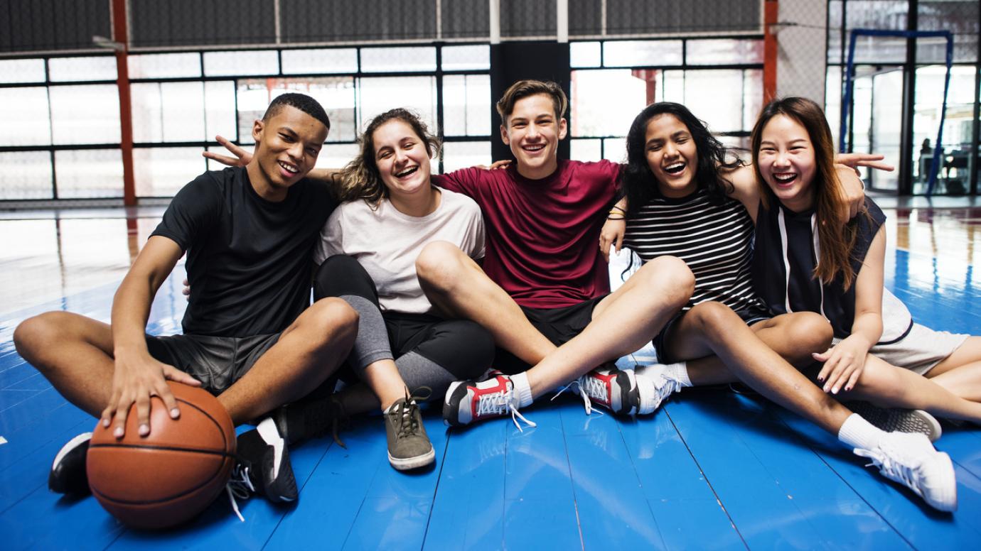 Group of young teenager friends on a basketball court