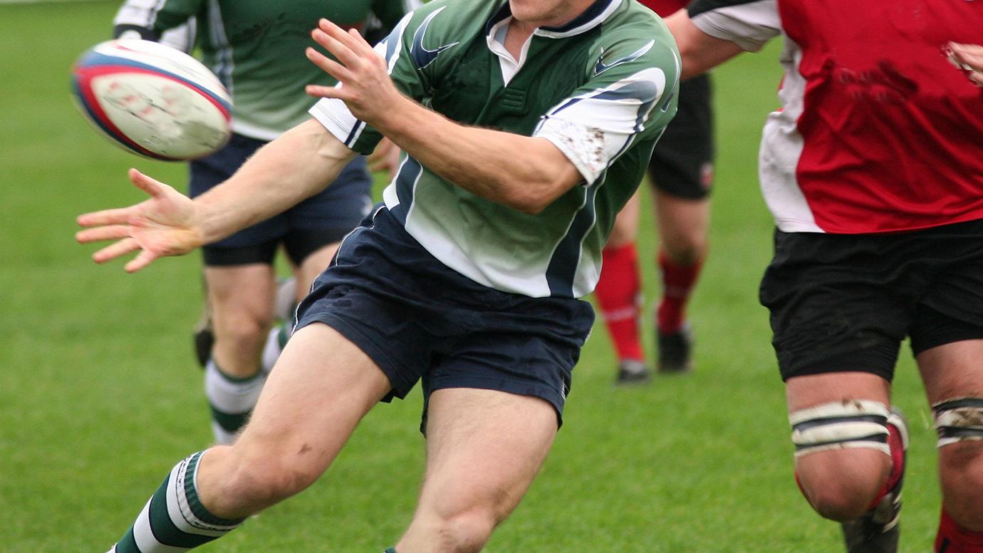 A rugby player passing the ball