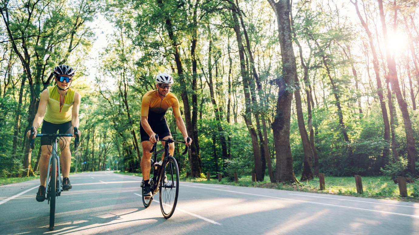 Two road cyclists riding side by side