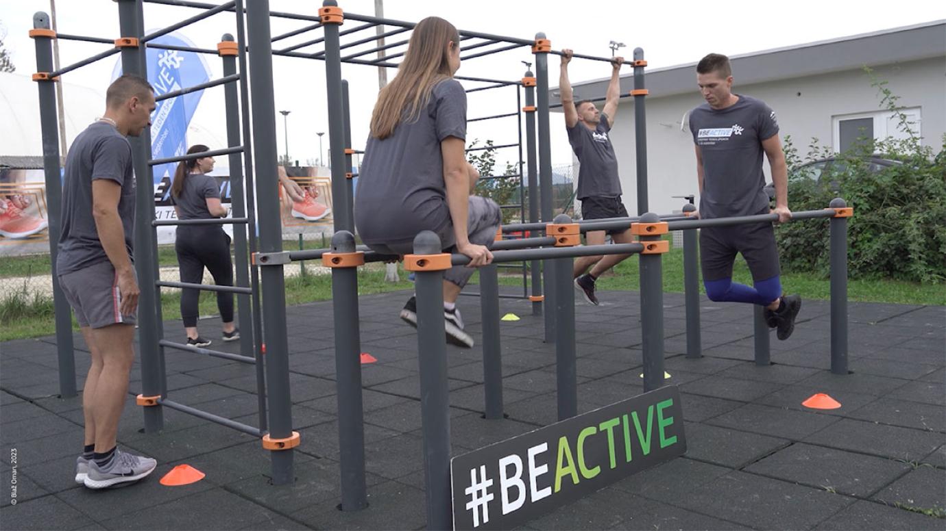 A group of young people exercising in an outdoor gym
