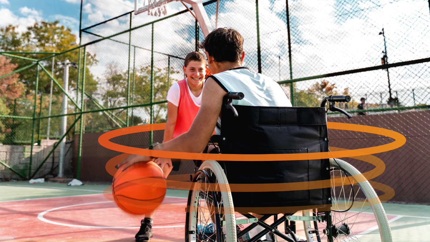 A wheelchair user and a friend playing basketball