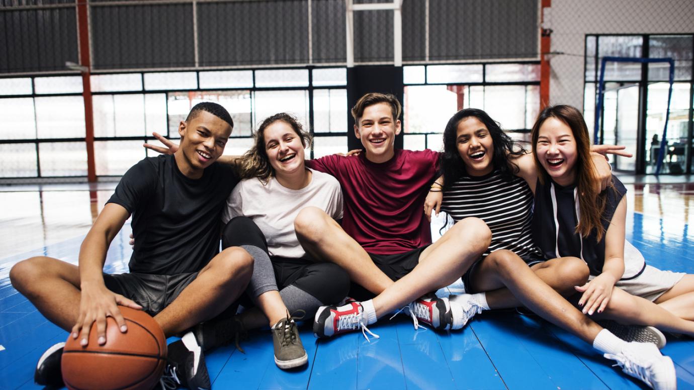 Group of young teenager friends on a basketball court