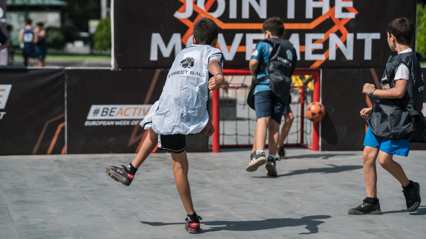 3 boys playing football